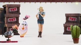 A blonde cowgirl in a green pig snout dances along with animated characters to Blake Shelton's end credits theme.