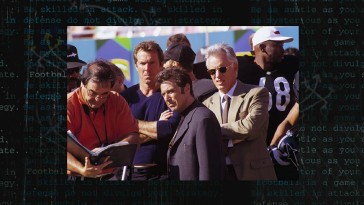 Director Oliver Stone consults his playbook while Dennis Quaid, Al Pacino, and James Woods await instruction in this gallery still.