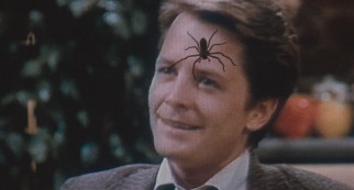 A televised Alex P. Keaton (Michael J. Fox) doesn't stand a chance against an "Arachnophobia" spider. (Recalled original pressing)