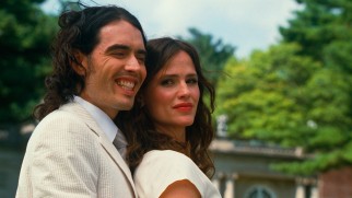 Arthur (Russell Brand) forces a smile for his engagement photo with Susan Johnson (Jennifer Garner).