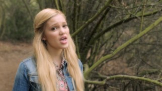 Olivia Holt keeps calm and sings outdoors in her "Carry On" music video.