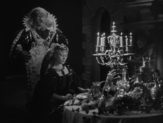Beast offers Belle feasts on an armed dinner table as his houseguest.