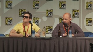 A shaded Johnny Knoxville moderates, while creator Mike Judge answers questions at Beavis and Butt-Head's 2011 San Diego Comic-Con Panel.
