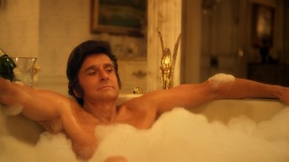 Liberace (Michael Douglas) likes to talk and think in a bubbly bathtub for two with a champagne flume nearby.