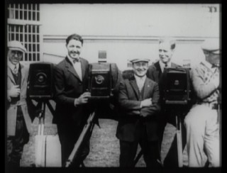 Still photographers proudly pose by their cameras in MGM's "1925 Studio Tour."