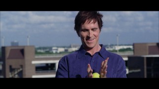 Michael Burry (Christian Bale) entertains himself with a tennis ball as he comes to terms with Asperger's self-diagnosis in this deleted rooftop scene.