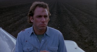 Sitting on his car hood in Texas farmland, a bloodied Ray (John Getz) wonders if he's done the right thing.