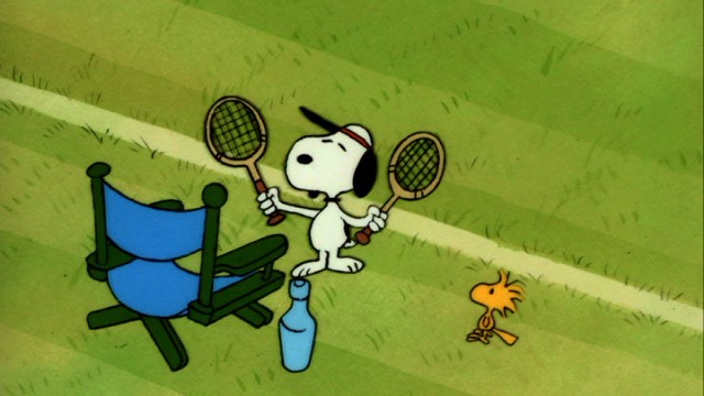 When in Wimbledon... Snoopy and Woodstock break off from the group to play some tennis.