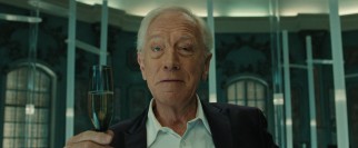 Marketing guru and fast food industry maker-over Joseph Pascal (Max von Sydow) gives a toast to a job well done.