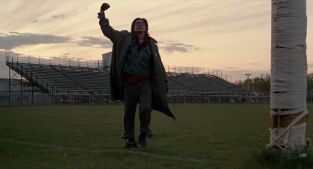 John Bender (Judd Nelson) throws up a fist as he walks across the football field in the film's memorable closing shot.