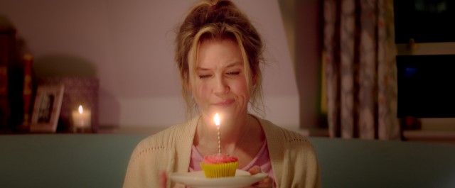 Bridget Jones (Rene Zellweger) is all by herself (again) celebrating her 43rd birthday with a cupcake in "Bridget Jones's Baby."
