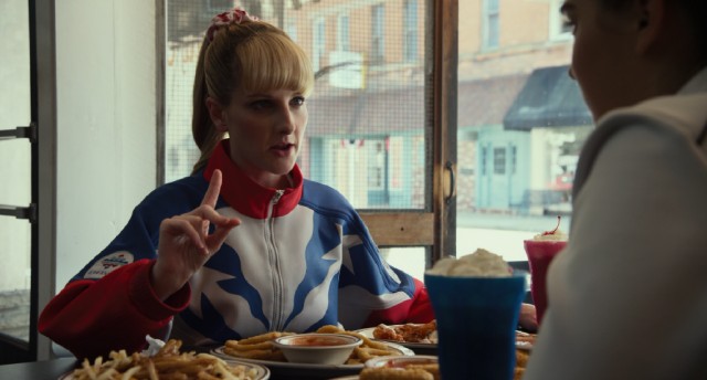 Hope Ann Greggory (Melissa Rauch) schools her pupil on the importance of fatty fast food in "The Bronze."