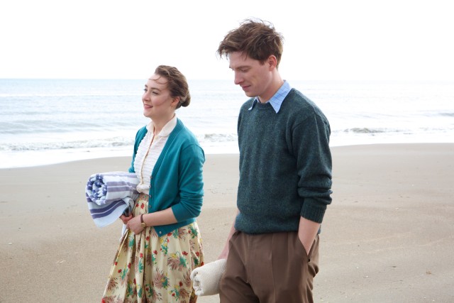 Back in Ireland, Ellis (Saoirse Ronan) enjoys a walk on the beach with rugby hunk Jim Farrell (Domhnall Gleeson).