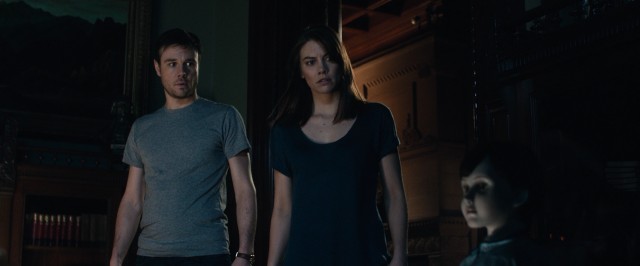 Who interrupted their bedtime fun with Victrola music? Malcolm (Rupert Evans) and Greta (Lauren Cohan) look to the seemingly inanimate yet obvious suspect: Brahms the doll.