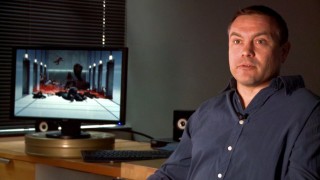 Visual effects supervisor Todd Shifflett talks in front of a shot of a bloody corridor in "Primal Terror."