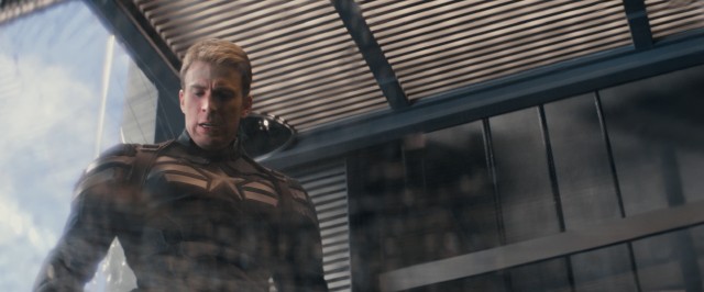 Captain America (Chris Evans) takes note of the damage he's done in a one-against-all glass elevator battle.