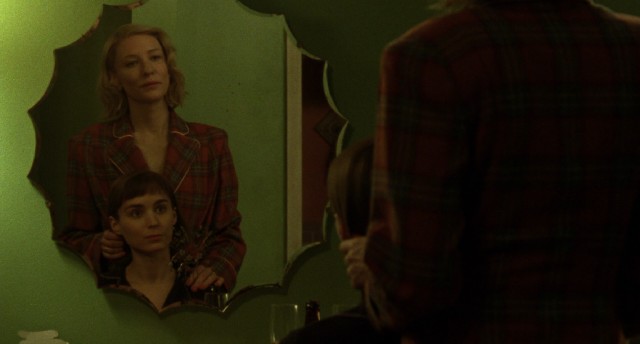 Carol (Cate Blanchett) and Therese (Rooney Mara) share a tender moment in a motel bathroom.