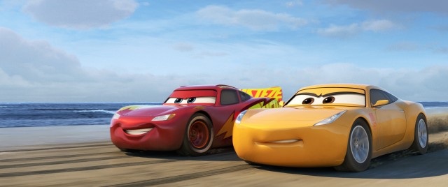 A recovering Lightning McQueen trains with Cruz Ramirez on the beach in Disney/Pixar's "Cars 3."