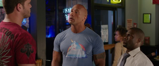 Don't be fooled by the unicorn shirt: Bob Stone (Dwayne Johnson) is about to stand up to a table of bullying bros to the excitement of Calvin Joyner (Kevin Hart).