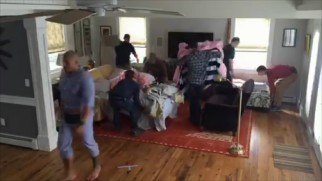 Crew members hurry to make a bed and change a set for a Dwayne Johnson stand-in in the "Couch Time Lapse."
