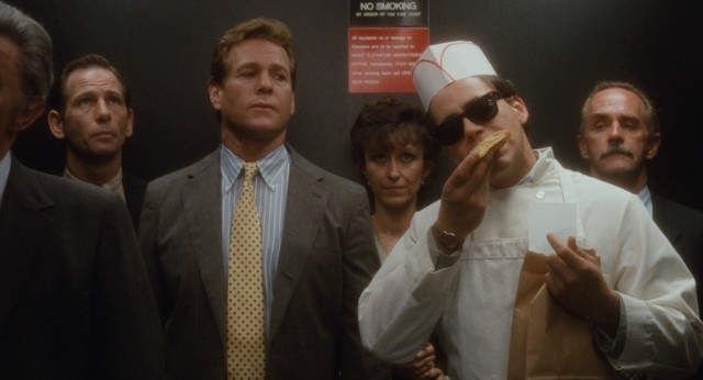 Philip (Ryan O'Neal) notices something strange about Alex (Robert Downey Jr.), who betrays his food delivery boy disguise with some noshing.