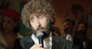 Jason Schwartzman sports a curly Afro and a thick beard as singer/comedian Kirby Star in a film by his first cousin Roman Coppola.