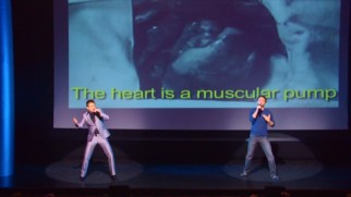 Hard (Chris Hardwick) 'n Phirm (Mike Phirman) perform "Corazn", which the English translations behind them reveal as a factual song all about the human heart.