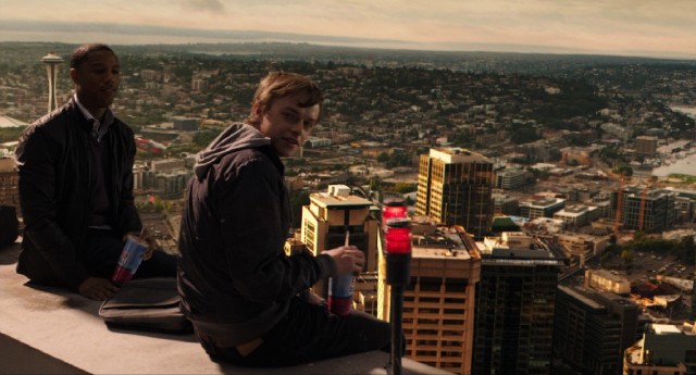 High above Seattle, Steve (Michael B. Jordan) and Andrew (Dane DeHaan) drink soda and use telekinesis to make their camera float.