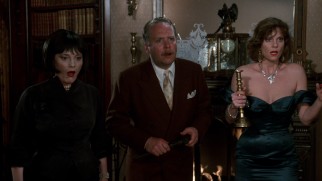 With randomly assigned lethal weapons in hand, Mrs. White (Madeline Kahn), Colonel Mustard (Martin Mull), and Miss Scarlet (Lesley Ann Warren) have a fright.