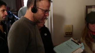 Tom McCarthy wears headphones while directing The Cobbler.