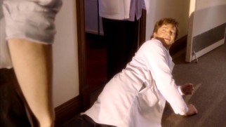 Dr. Leonetti (Rhys Darby) goes to extreme lengths to preserve his imagined disability, even crawling around on the ground as needed.