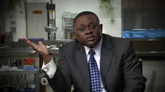 The real Dr. Bennet Omalu looks nothing like Will Smith, something "Inside the True Story" reveals.