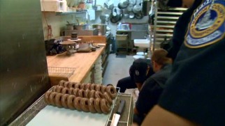 Cops swarm to a donut shop after hours...strictly for business.
