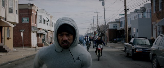 Adonis Creed (Michael B. Jordan) runs fast ahead of motorcyclists, while his clothing pays respect to another Michael Jordan.