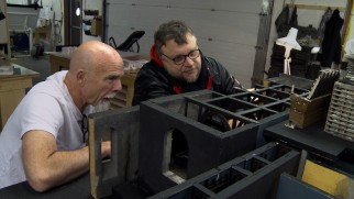Guillermo del Toro looks at a model of the Sharpe mansion in "A Living Thing."