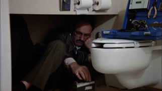 From a bathroom floor, skilled bugger Harry Caul (Gene Hackman) eavesdrops on the hotel room next door.