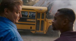 Phil and Charlie give each other a knowing look as a school bus full of kids crashes into the cabin, marking the camp's first of many mishaps under new management.