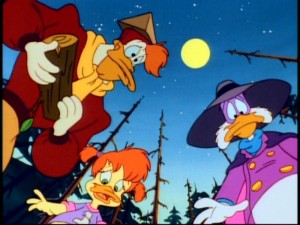 Left to right, Launchpad McQuack, Gosalyn, and Darkwing Duck discover what appears to be a dead body on the ground. The less said about Launchpad's hat, the better.