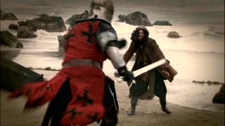 The dramatized battle between knight and pirate ends up on a beach.