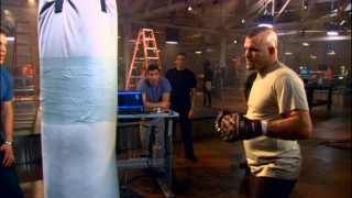 Former UFC champion Chuck "The Iceman" Liddell tests out gladiatorial cesti (spiked gloves) on this punching bag.