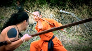 A Shaolin monk clad in orange tells a fierce Maori warrior to talk to the hand.