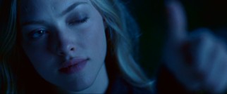 Savannah (Amanda Seyfried) gives a wink and thumb up while covering the moon with an old perspective trick.