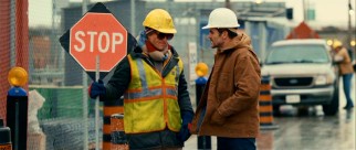 Arthur (Woody Harrelson) would be much less tired and bruised at his day job if Hammertown's criminals only needed a stop sign like construction zone drivers. Though he looks confrontational here, Arthur's foreman (Michael Kelly) is his one friend.