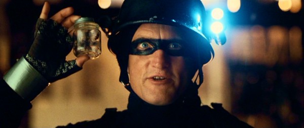 Defendor (Woody Harrelson) proudly holds one of the most potent items in his arsenal: a jar of wasps ready to swarm.