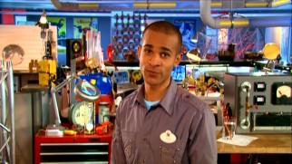 Amusing host Imagineer Asa Kalama stands and teaches from this busy, colorful laboratory room.