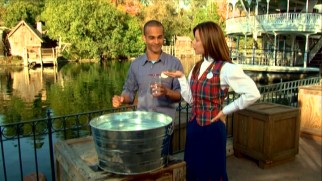 A Disney cast member has just what Asa Kalama needs to demonstrate the displacement of water in front of the Mark Twain Riverboat.