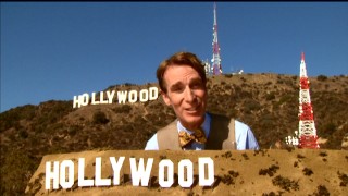 Bill Nye stands between the famed Hollywood sign and a scale model of it in a Pre-Algebra segment teaching proportions.