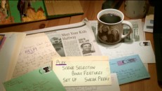 In the subtly-animated main menu, the options are listed on an index card placed on a somewhat cluttered but ordinary table.