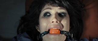 Alice Creed (Gemma Arterton) is bound, cuffed, gagged, slapped, and inexplicably forced to wear a purple sweatsuit. Still, this isn't a "Saw"-type torture movie.