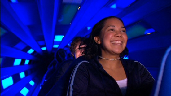 This Space Mountain rider is all smiles to be moving through the ride's energizing tunnel of blue light.